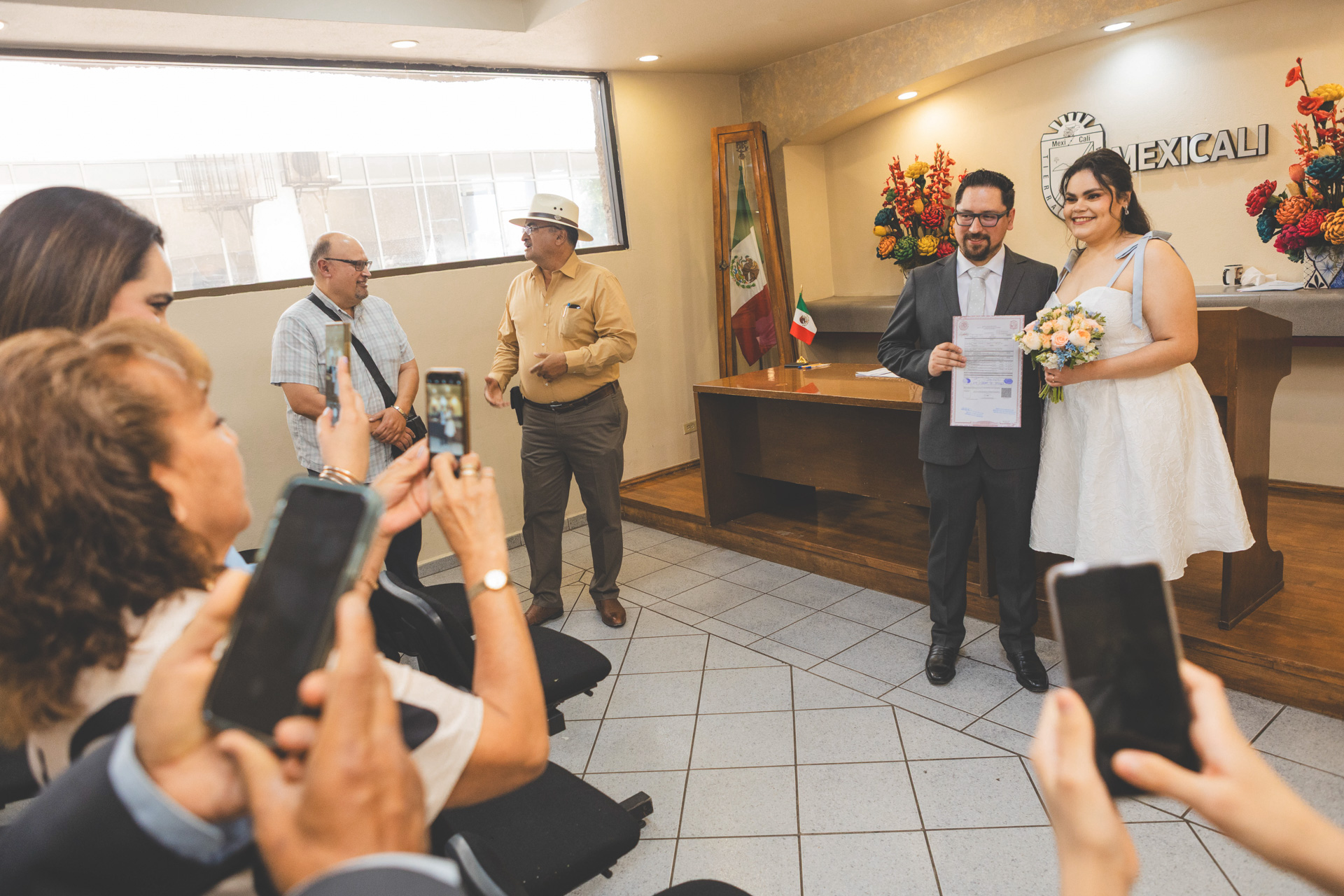 Boda Civil de David y Cristina en Mexicali | Fotógrafos Profesionales y Accesibles – Los Full | Fotografía y Video en Mexicali | 9 | Los mejores fotógrafos y videógrafos en Mexicali Familia tomando fotos en boda civil en Mexicali abril 2025, Registro Civil Baja California, fiesta sencilla, foto de ambiente familiar, los mejores fotógrafos de boda civiles, piñatas y quince años en Mexicali, fotografía espontánea y accesible, losfull.com. Económico, barato, 1 hora, fotografía y video profesional para bodas.